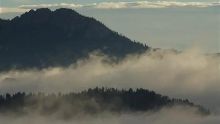Wooded mountain in the sun with misty valleys, photo credit: Pat Mingarelli