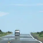 Car driving on heat shimmering road: Photo 93795127 © Artesiawells | Dreamstime.com