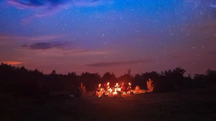 People grouped around campfire by night: Photo 84221874 / Campfire © Roksana Bashyrova | Dreamstime.com