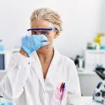 Scientist smelling something gross: Photo 239812848 © Aaron Amat | Dreamstime.com