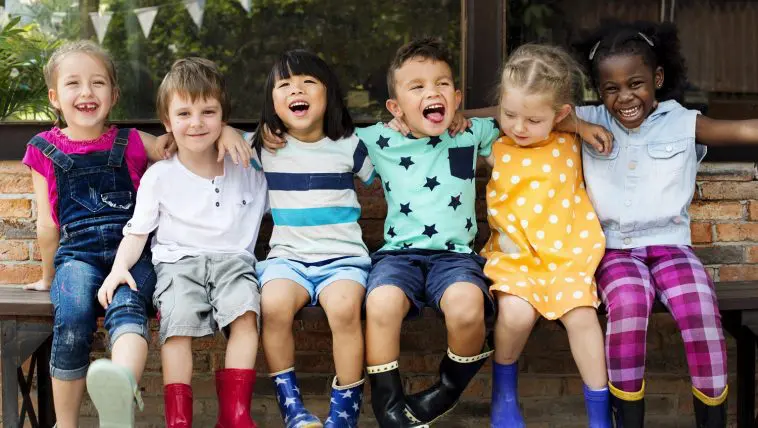 Young children sitting in a line: Photo 97130789 © Rawpixelimages | Dreamstime.com