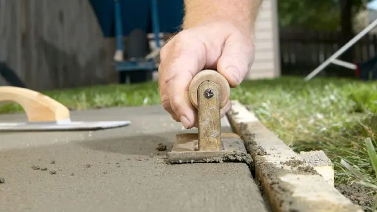 Smoothing wet cement: Photo 98115085 © Colby Lysne | Dreamstime.com