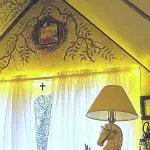 Home office with fairy lights around the window and a painted was with "Hope" wreath