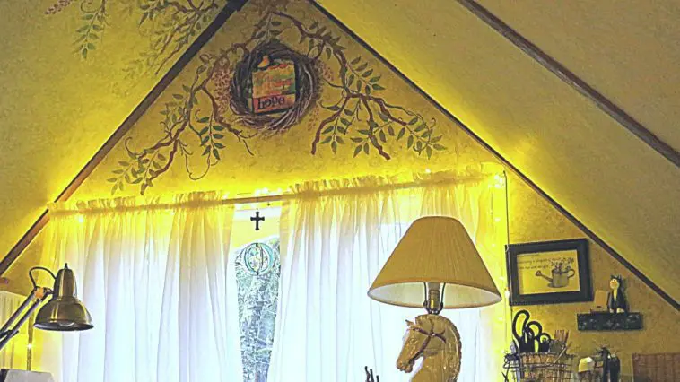 Home office with fairy lights around the window and a painted was with "Hope" wreath