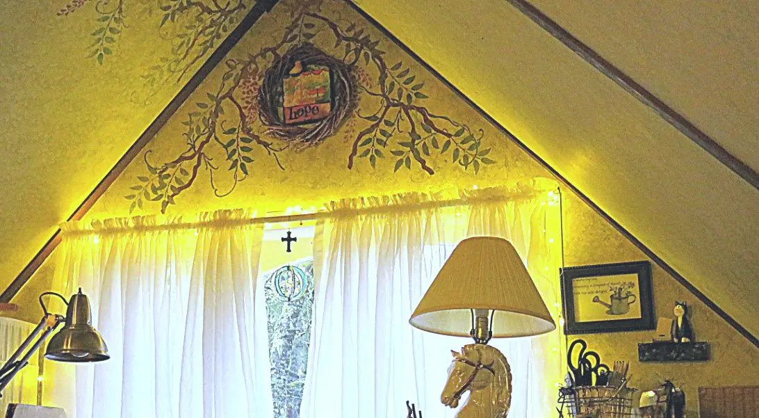 Home office with fairy lights around the window and a painted was with "Hope" wreath