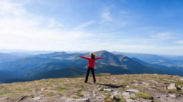 Woman on mountain top with hands outstretched: Photo 27340093 © Aikidoki | Dreamstime.com