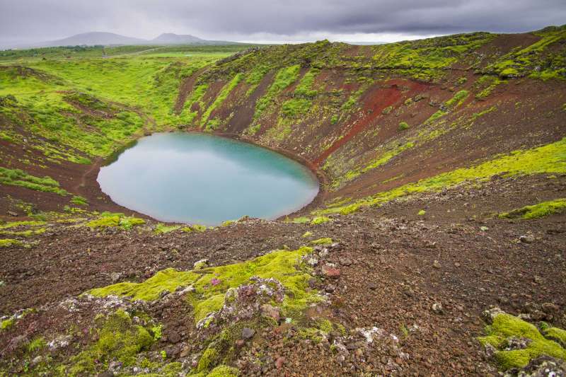 Volcanic crater covered in greenery with lake