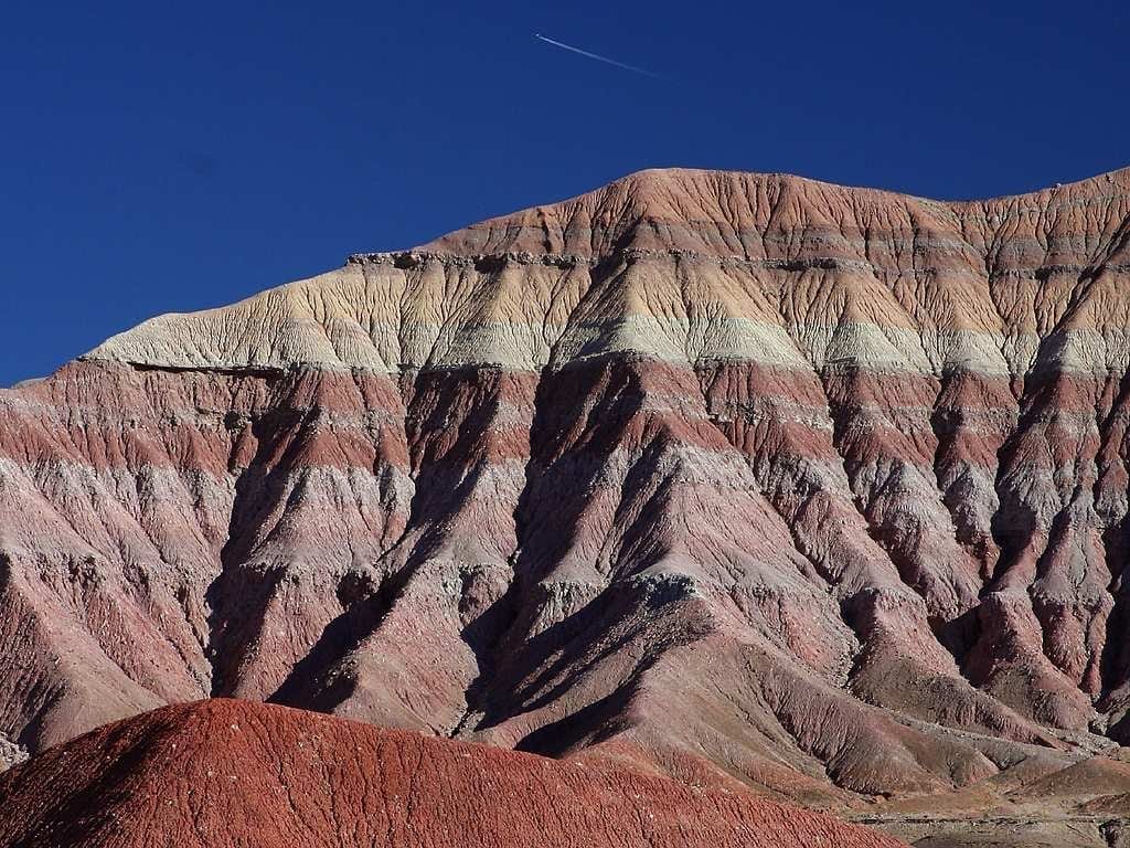 Flat sedimentary layers showing through bare eroding hillside
