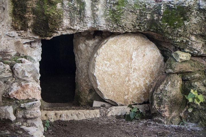 Rock-cut tomb with round stone rolled back