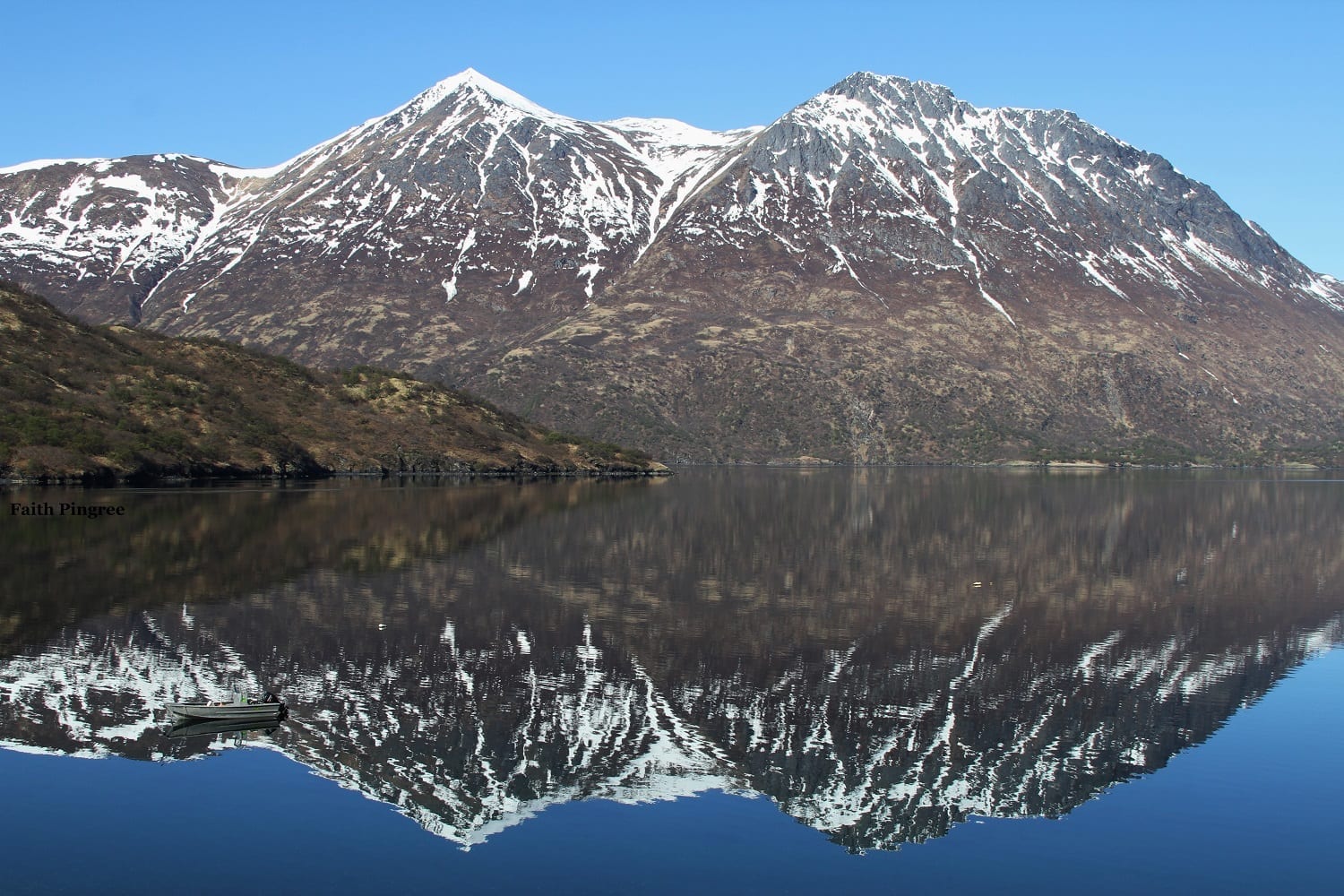 Snow dusted mountains with lake reflections