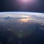 Earth from above showing thunderheads above the ocean reflecting sunlight, photo credit: NASA