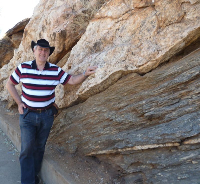 Anzac Hill roadcut with Tas Walker against the rock layer boundary