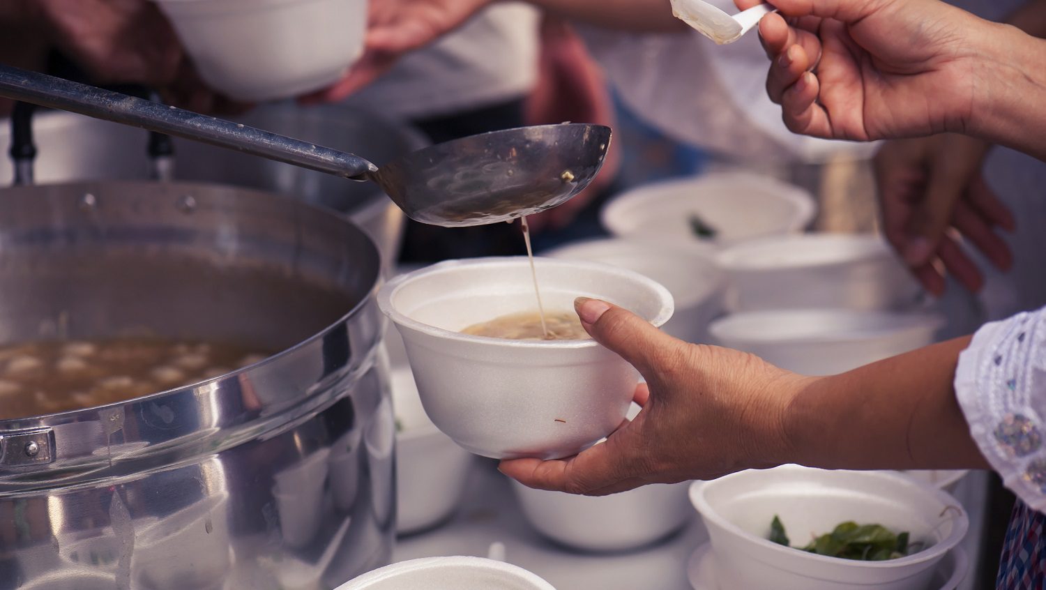 Hands passing out bowls of soup to the homeless: Photo 118467980 / Feeding Homeless © Todsaporn Bunmuen | Dreamstime.com