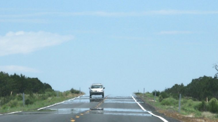 Car driving on heat shimmering road: Photo 93795127 © Artesiawells | Dreamstime.com