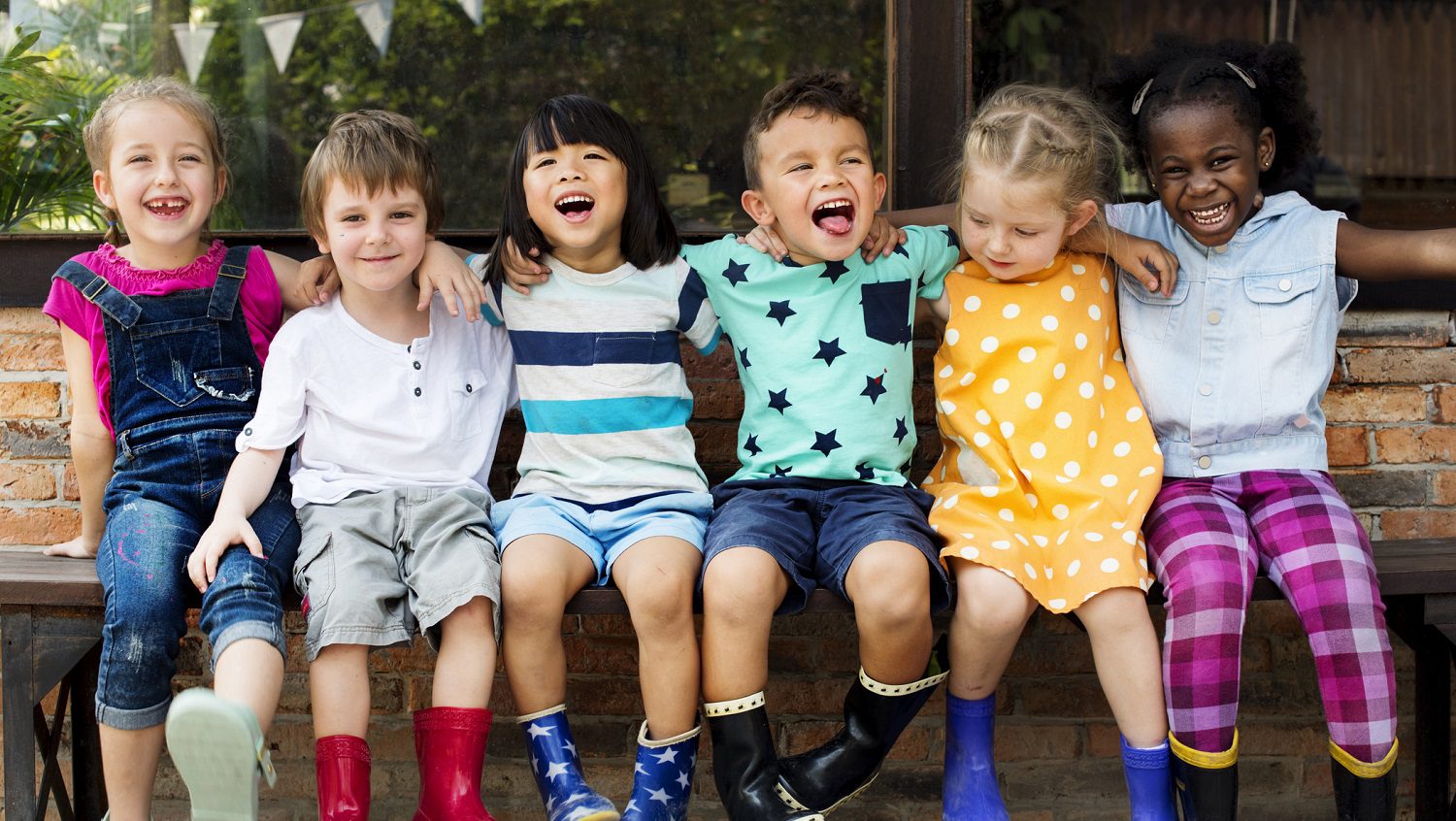 Young children sitting in a line: Photo 97130789 © Rawpixelimages | Dreamstime.com