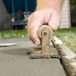Smoothing wet cement: Photo 98115085 © Colby Lysne | Dreamstime.com